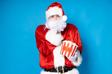 Santa Claus, a cheerful Santa with popcorn in his hands.