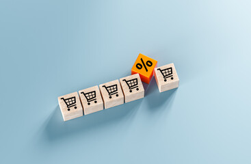 sales growth. shopping cart icon and percentage sign on cubes laid out on blue background. Increase...
