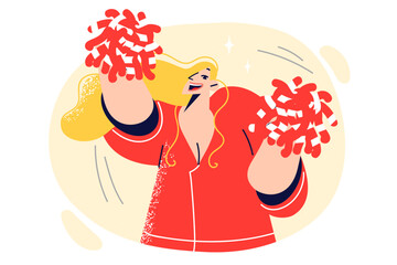 Woman cheerleader waves hand with pompoms and dances festive dance to motivate athletes to play well © Valery