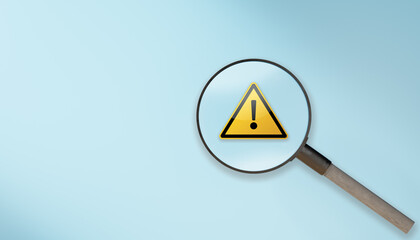 magnifier glass with yellow triangle caution warning sign on blue background. Attention, Warning,alert icon,caution dangerous concept. Root cause analysis or solving problem