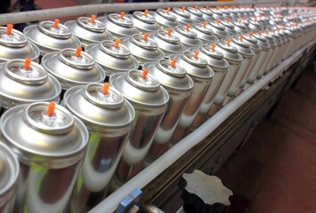Aerosol cans being manufactured in aerosol factory