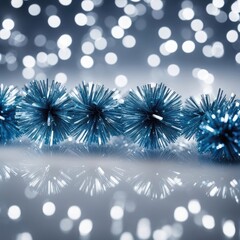 Christmas background with blue tinsel on bokeh defocused lights