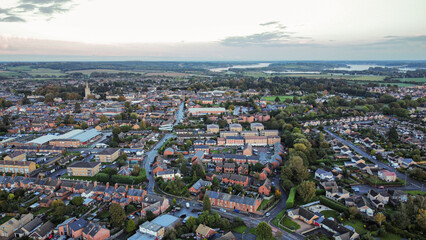 Aerial view 4k small town at sunset in Rutland, UK. 
