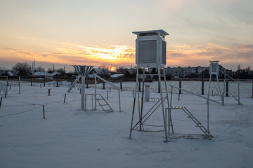 Weather station in the evening during sunset in winter. A device at a weather station for recording the weather close-up.