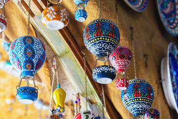 Handmade ceramics souvenirs in form of colorful hot air balloon selling in gift shop in Goreme. Typical souvenir or gift from Cappadocia, Turkey (Turkiye)