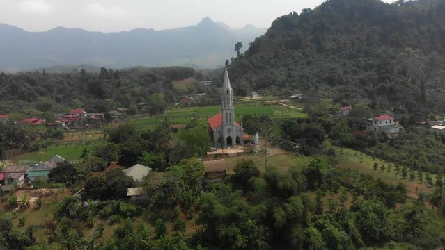 Flying towards Gi&aacute;o Xứ Bạch Xa Catholic Church at Tuy&ecirc;n Quang Vietnam, aerial