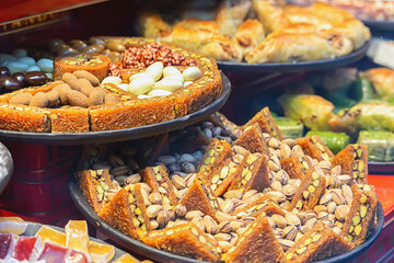 Traditional Dessert Turkish Baklava. Walnut, Pistachio Turkish Style Antep Baklava Presentation. Baklava from Turkish cuisine. Close up, selected focus