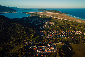 Coastline with ocean and town with sunset tones in Campeche, Florianopolis