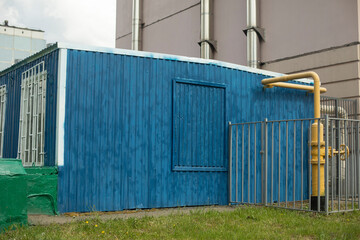 Fototapeta na wymiar Blue Technical Building. Heating station near house. One-storey building.
