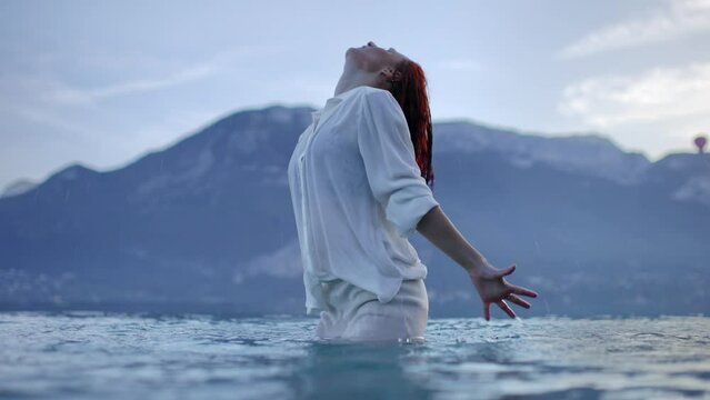 Woman dancing in a lake
