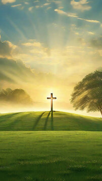 The sun's rays at dawn, in a meadow, are projected on an illuminated cross, a painting effect. Vertical reminder