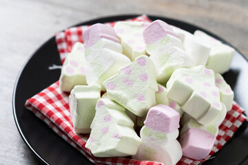 Christmas marshmallow with Christmas tree and snowman shape on wooden table. Close up