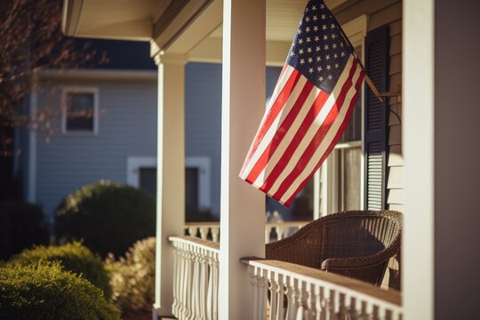 USA flag on building porch expresses patriotism reflecting love for country. USA flag on porch of house unmistakably radiates sense of patriotism signifying national allegiance. Cropped photo. - Powered by Adobe