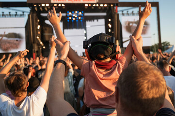 Applause of a boy with headphones during music concert