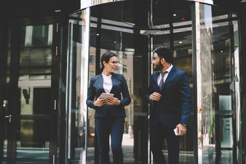 successful economists in stylish suits discussing cooperation