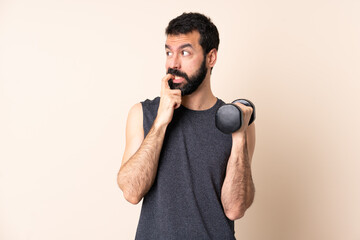 Caucasian sport man with beard making weightlifting over isolated background nervous and scared