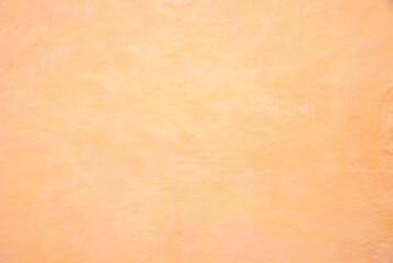 concrete wall with soft spatula technique, light apricot painted with a brush