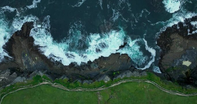 The mighty waves of the ocean crashing against the cliffs of Moher 4k