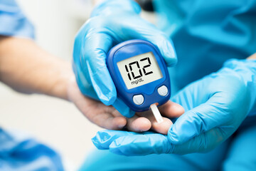 Doctor check diabetes from finger blood sugar level with finger lancet. - obrazy, fototapety, plakaty