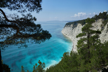 Fototapeta na wymiar Blue azure sea against a background of white sheer cliffs. Seascape of coastline, beautiful nature, landscape. Tourism travel