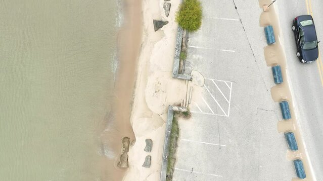 An endangered shoreline buffed with various measures to keep the sand in place.