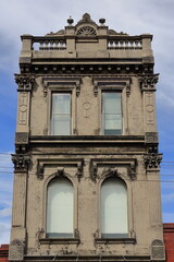 West facing front of three-storey, historic terraced building with rendered facade on Brunswick Street. Melbourne-Australia-990