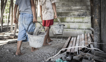 Poor children forced to do construction work, child labor, abuse To the rights of children, victims of human trafficking, World Day Against Child Labor. - obrazy, fototapety, plakaty