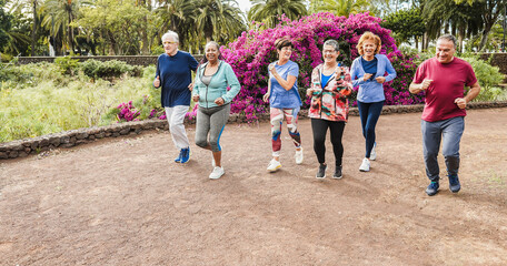 Fit senior people running at city park - Group of elderly friends doing sport workout together...