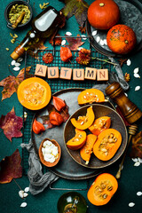 Banner: hello autumn. Orange pumpkins on a stone table, holiday decoration. Pumpkin menu. Top view.