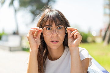 Young woman at outdoors With glasses and frustrated expression