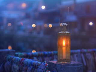 Vintage lamp with candle inside over blurry hostel background with pentagon bokeh - 669943178