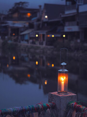 Vintage lamp with candle inside over blurry hostel background with pentagon bokeh - 669943180