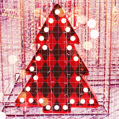 Christmas background. Decorative red Christmas tree illuminated with bright lights and garlands. New Year's decor on the city streets.