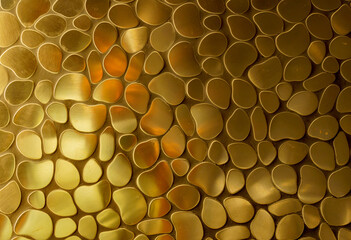 Golden wall in the form of glossy pebbles
