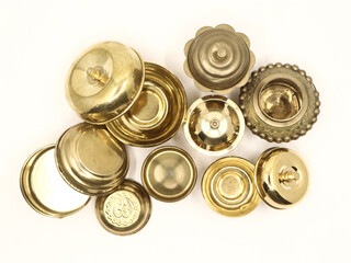 a set of golden vintage box, jar and bowl in luxurious design crafted in brass isolated in a white background