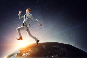 Portrait of energetic businessman jumping in open air