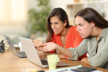 Angry tele workers complaining checking laptop