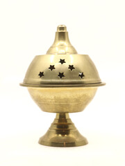 a divine incense holder diya lamp of unique shape made of golden brass metal used for religious...