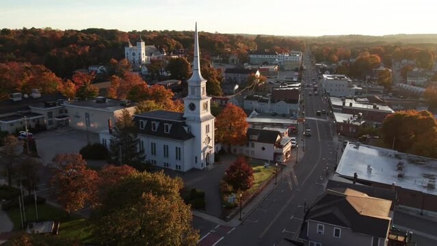 Circling around a church on main street at sunrise in October in Hudson, Massachusetts.