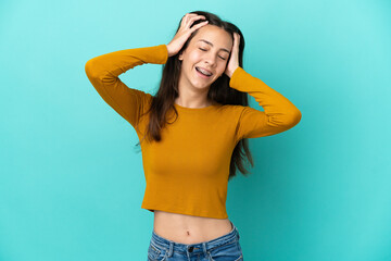 Young French woman isolated on blue background laughing