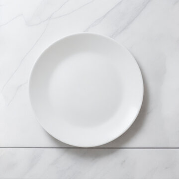 a white empty plate on a white marble table