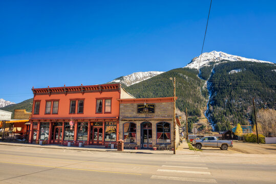 Silverton, Colorado, USA - October 15, 2018 : Silverton Historic District with snow on the mountains behind. Silverton was a silver mining camp and is a National Historic Landmark.