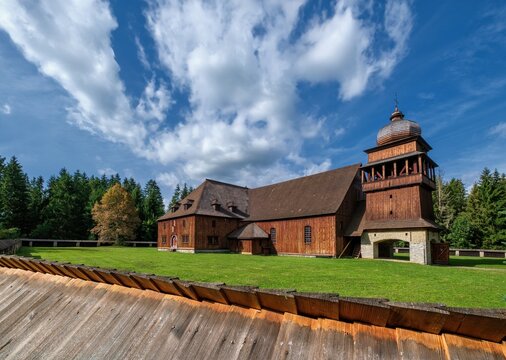 Wooden evangelical articular church of the Svaty Kriz(Holy Cross), is one of the largest wooden churches in Europe.Green meadow, blue sky white clouds, old architecture. Paludza, Svaty Kriz.