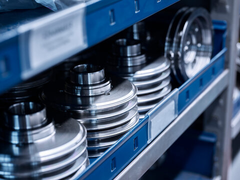 Metal spare parts on shelf at warehouse