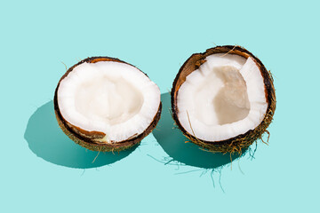 Halved coconut against blue background
