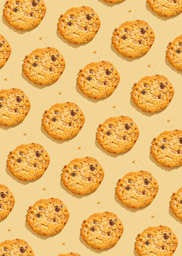 Raisin cookies arranged against yellow background