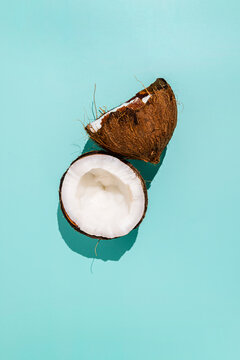 Broken coconut against blue background