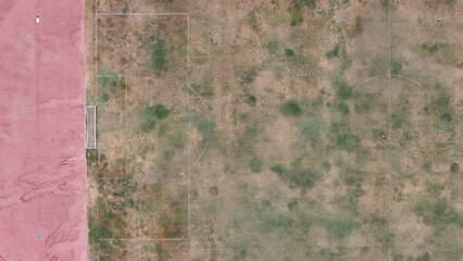 A top view on a soccer pitch with deteriorated grass surface