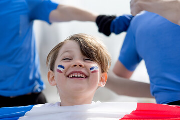 Face of a young sportsgirl supporting French athletes