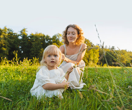 Mother and daughter spending time together on grass